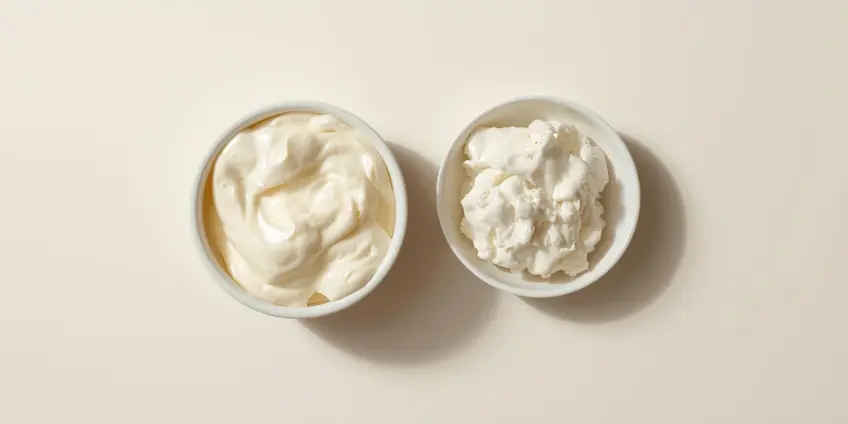 A side-by-side illustration comparing a tub of cream cheese to a bowl of blended cottage cheese.